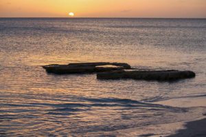 Sun Setting over Horizon of Ocean at Pelican Beach, Turks and Caicos